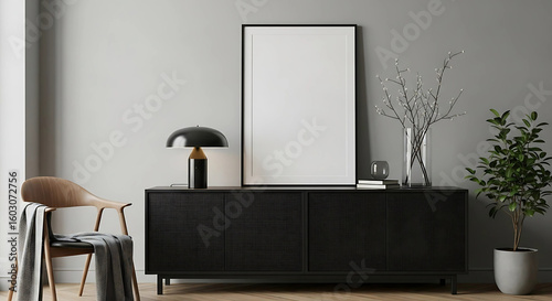 Modern living room interior with black sideboard empty frame chair and potted plant