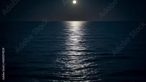 Serene moonlit ocean view at night with shimmering water reflecting the moonlight and calm waves