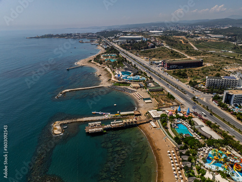 Fototapeta Naklejka Na Ścianę i Meble -  Stunning aerial day view over Turkler in Alanya, Turkey. Alanya coastline,resorts,marina,hotels and crystal clear turquoise water along the Mediterranean Sea. Mediterranean Sea turquoise coastline.