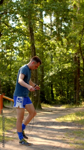 This video features a mans dynamic outdoor workout, starting with him jumping a fence, then stretching and jumping rope in a park, and reflecting on natures invigorating activity