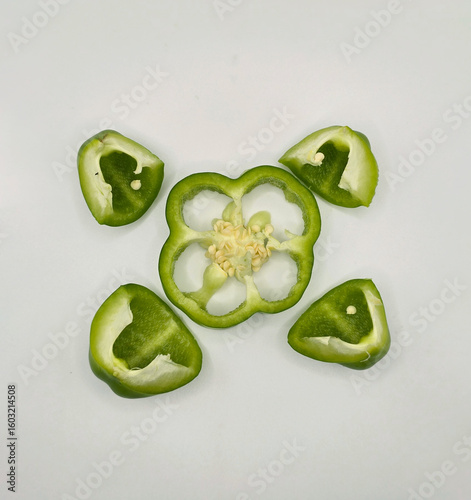 Fresh cut capsicum or, green bell peppers on white background. Whole and cut green bell peppers on white background, top view. high resolution salad image.