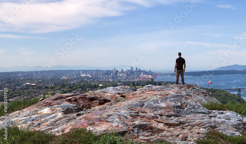 Back View of Man Admiring City Skyline and Nature