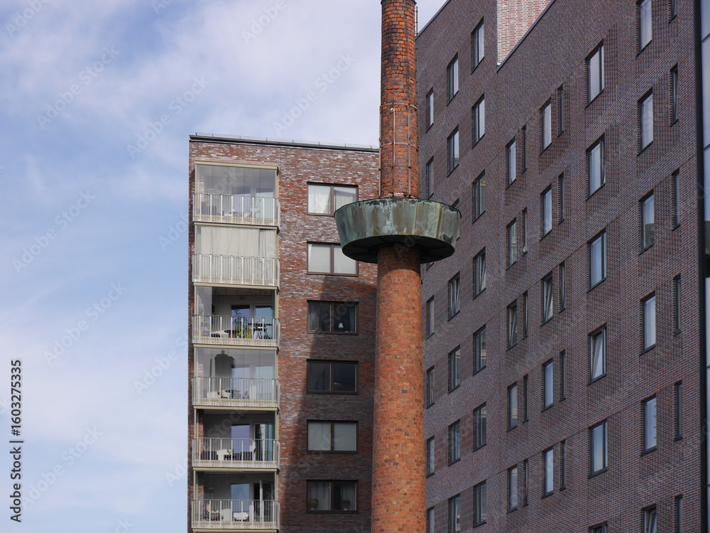 custom made wallpaper toronto digitalAn old chimney in front of modern buildings.