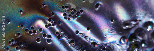 Horizontal Macro of Bubbly Iridescent Liquid with Rainbow Light Waves
