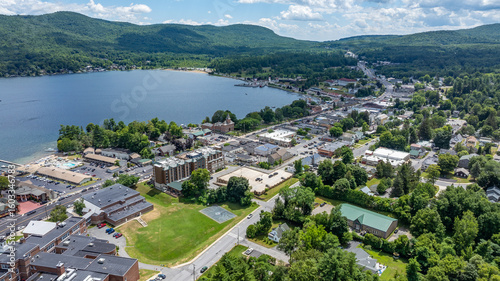 Fototapeta Naklejka Na Ścianę i Meble -  July 21, 2025 - Lake George, NY, USA.  Sunny afternoon summer aerial image of the south end of Lake George and Canada Street, Lake George, NY, USA.