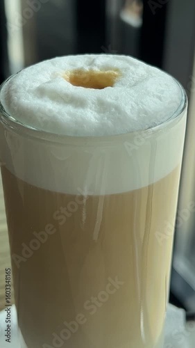 use a teaspoon to scoop up the foam Girl stirring coffee in restaurant. High quality 4k footage
