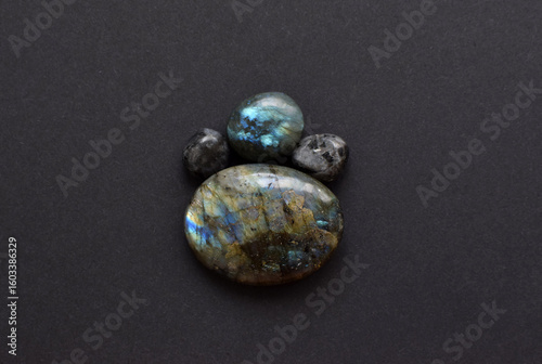 Beautiful natural labradorites with iridescence   a dark gray background. Healing crystals, semi-precious stones