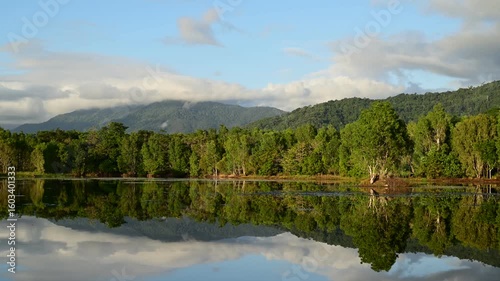 Early morning timelapse at Lake Jabiru in the Cattana Wetlands, north of Cairns, Queensland, with mist rising over still water and the Macalister Range forming a tranquil backdrop.