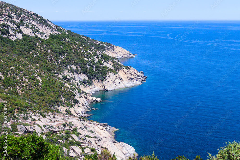 Rocky coastline with lush green hills Rocky coastline with lush green hills
