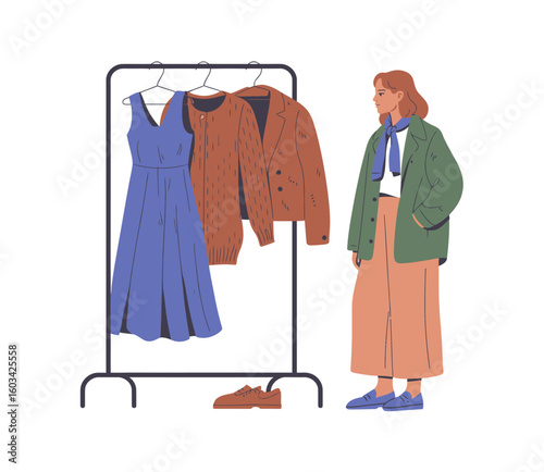 A young woman stands in front of a clothing rack, contemplating her choices, emphasizing fashionable clothing and personal style in a modern shopping environment.
