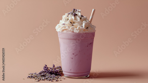 Elegant lavender milkshake topped with whipped cream and lavender buds, presented on a soft pink backdrop