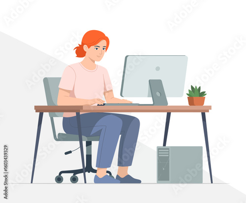 A young woman actively engages with her computer at a stylish office desk, illustrating the modern work-from-home environment and focus on productivity. Ideal for lifestyle themes.
