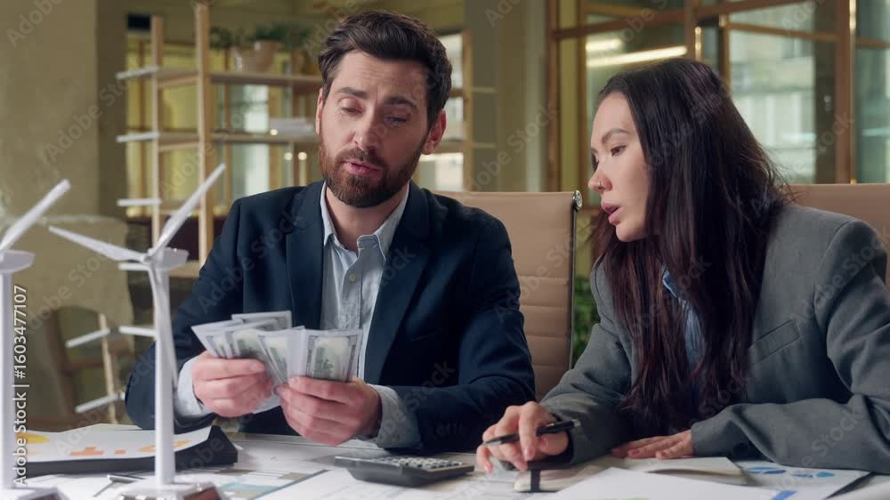 Ecology windmills project finance calculating multiethnic business engineers Korean woman writing budget plan report Caucasian man counting money eco funding strategy green energy investment office