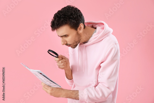 Young man with magnifier re...
