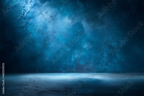 Photo of dark moody concrete studio backdrop with dramatic blue lighting creating an atmospheric and textured background