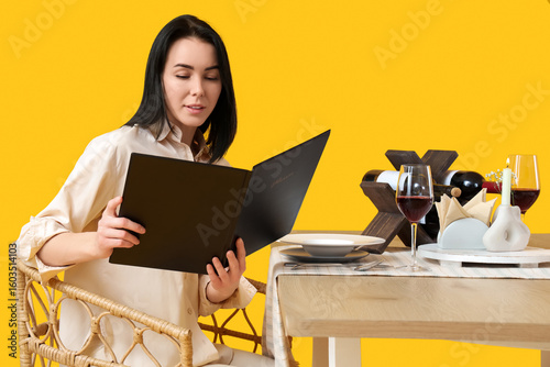 Young woman with menu at re...