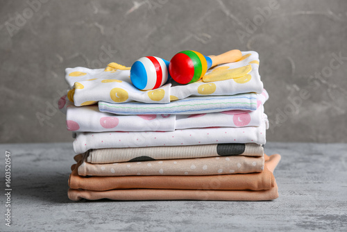 Stack of baby clothes with ...