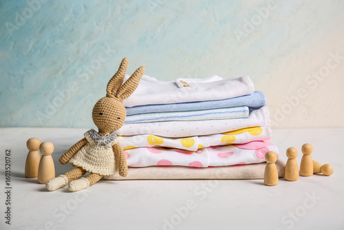 Stack of baby clothes with ...