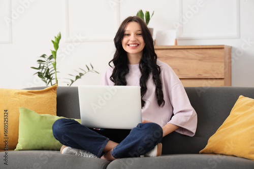 Teenage girl with laptop wo...