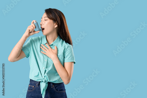 Young Asian woman using inh...