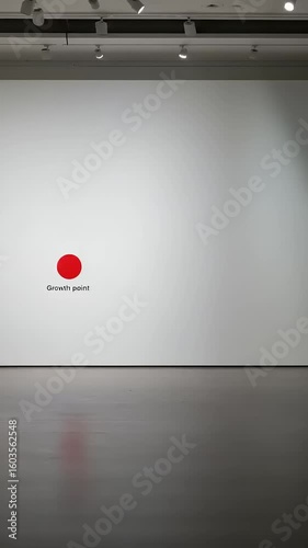 Red dot on white wall in modern art gallery setting