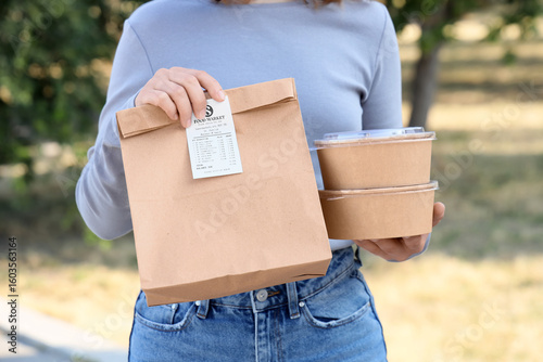 Woman with paper bag and co...