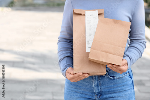 Woman with paper bags outdo...