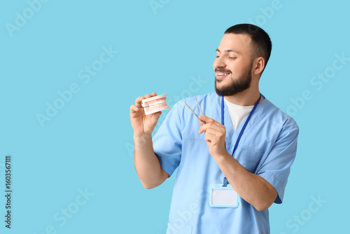 Male doctor with jaw model ...