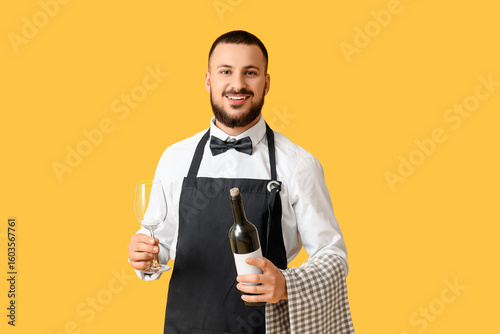 Male waiter with bottle of ...
