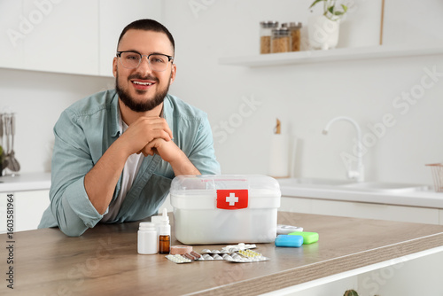 Young man with first aid ki...