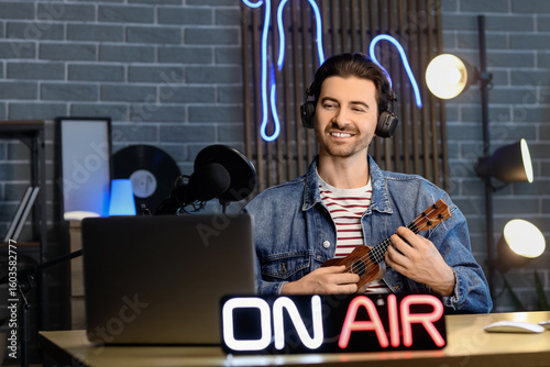 Male radio presenter playin...