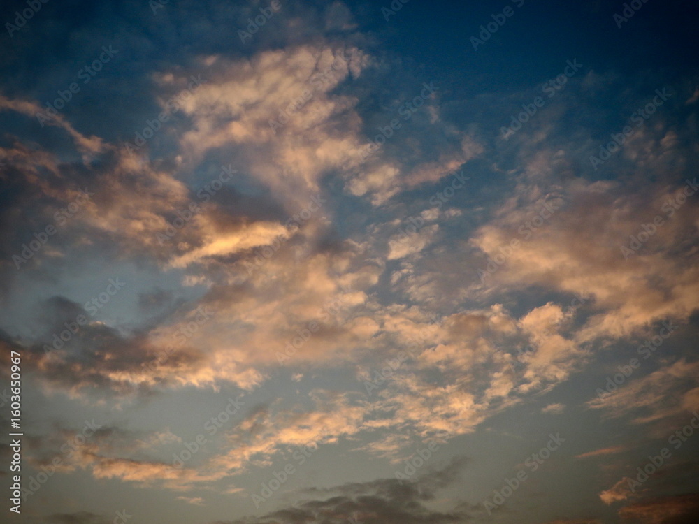 Fototapeta premium Dramatic Sunset Cloudscape: Golden Beams Slice Through a Moody Blue Sky in Tam Coc, Ninh Binh, Vietnam