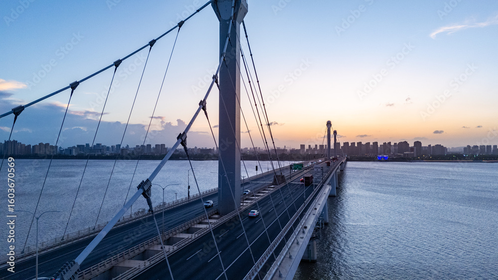 Obraz premium aerial view bridge over river during sunset