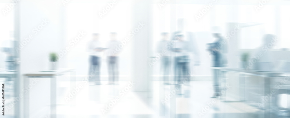 Fototapeta premium Blurred figures in a bright white office space suggest business or professional setting.