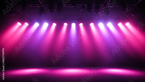 Combination of pink and purple stage lights with vibrant effect focusing at the center of the empty stage background