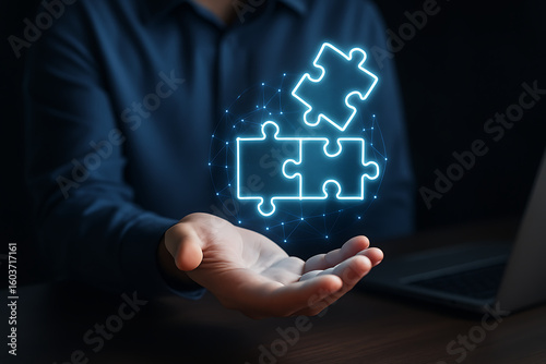 Businessman use laptop with jigsaw icon for solution and leadership strategies concepts.new
