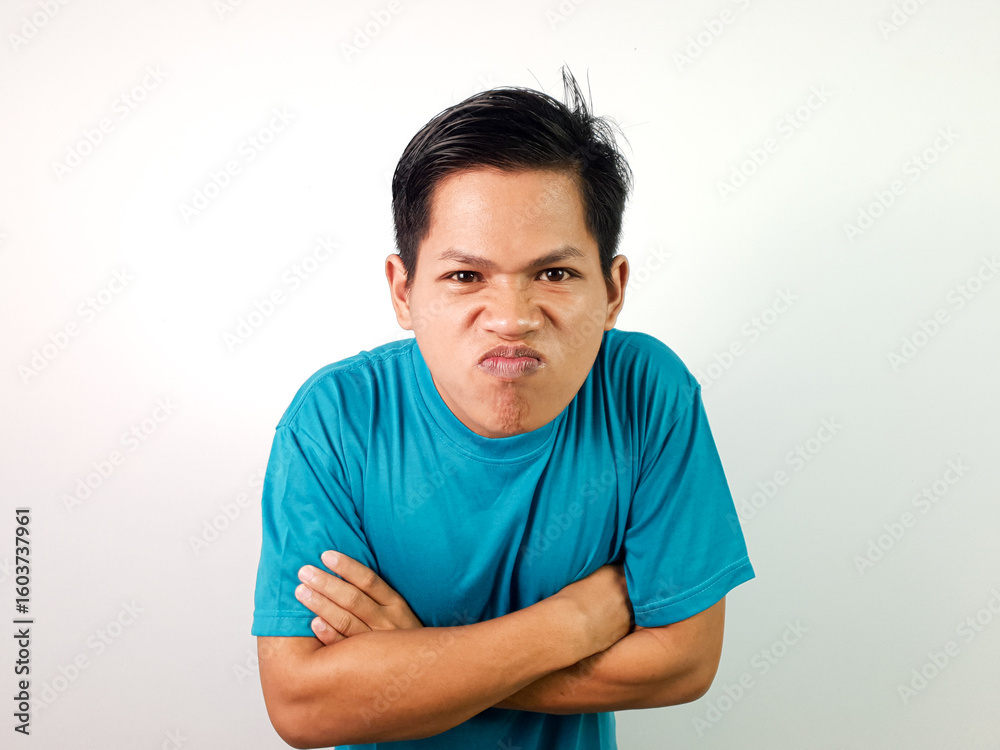 Fototapeta premium Happy Young Asian Man Smiling Positively With Folded Arms in a Blue Shirt