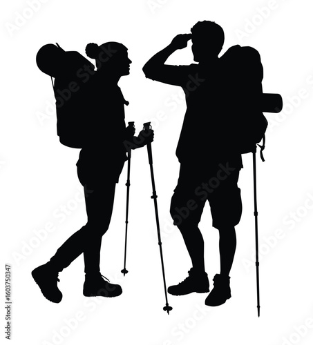 Silhouette of a couple hikers with backpacks and hiking poles