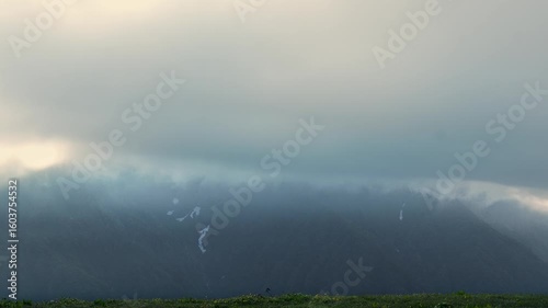 Seamless looping animation of dark thunderstorm clouds moving dramatically across the sky along the Madmaheshwar Temple trek, near Ransi Village, Uttarakhand, India.