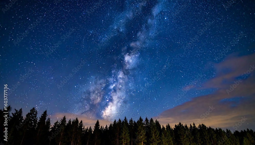 Fototapeta premium Enchanting celestial vista above a tranquil forest landscape during twilight hours