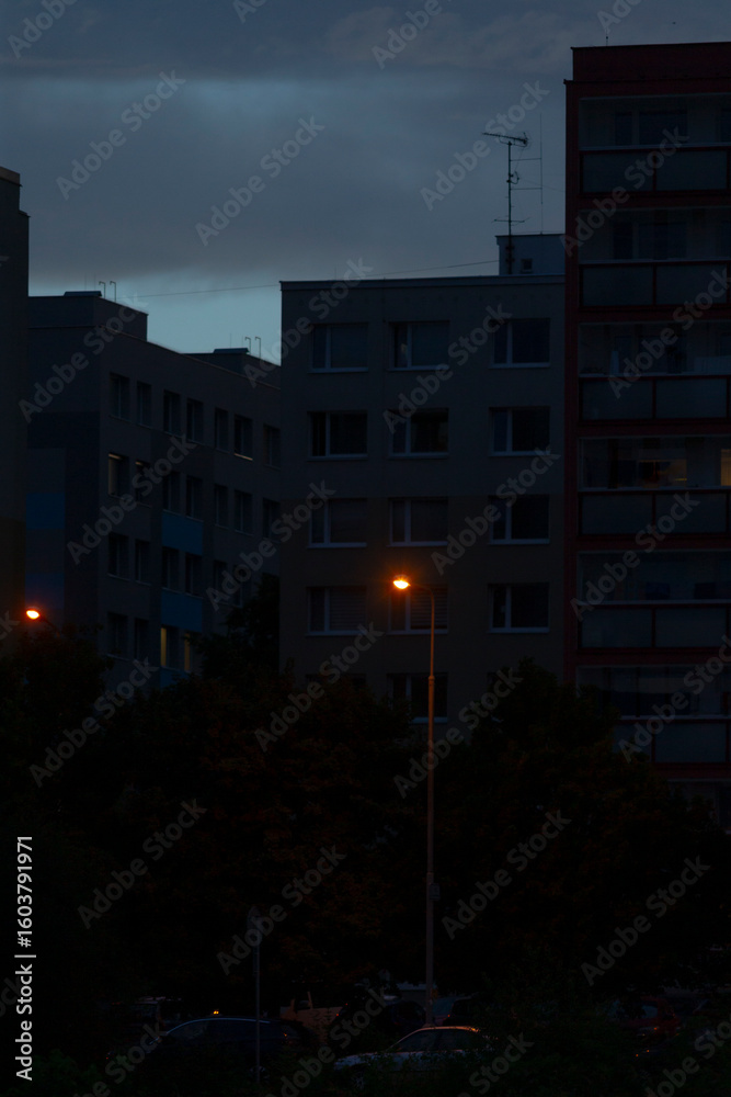A vibrant city at night featuring a glowing street light in the foreground, with tall buildings visible in the background, creating a stunning skyline A vibrant city at night featuring a glowing street light in the foreground, with tall buildings visible in the background, creating a stunning skyline