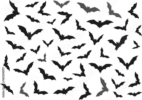 A multitude of black bat silhouettes in various flying poses against a white background creating a spooky halloween atmosphere