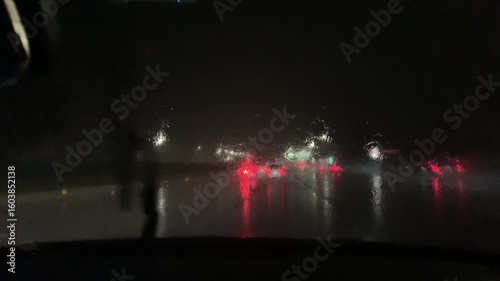 Driving through heavy rain at night with low visibility and wet roads