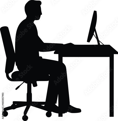 Silhouette of a person sitting at desk working on computer in office, focused and productive