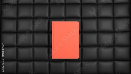 Coral notebook centered on black quilted background