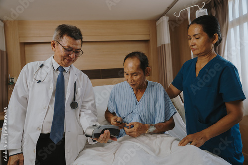 Patients are using money and credit cards to pay for medical services after successful treatment.