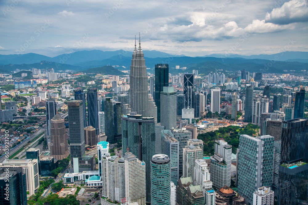 Fototapeta premium Kuala Lumpur, Malaysia - December 28, 2019: Dramatic aerial view of Kuala Lumpur skyline on a cloudy day with misty skyscrapers
