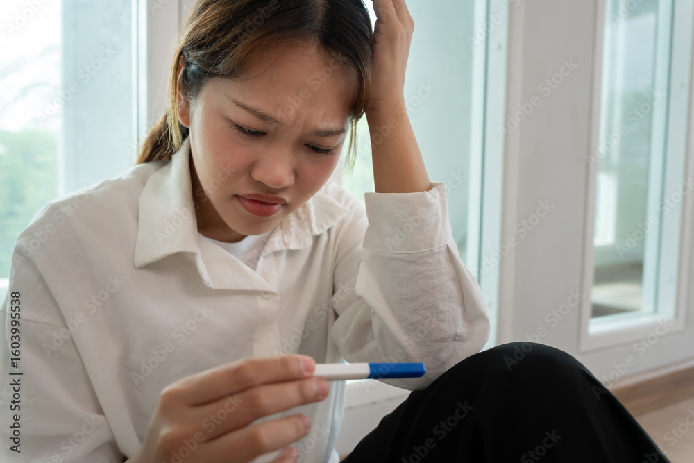 Naklejka premium Depression and mental illness. Asian woman stressed from premarital pregnancy. Stressed girl confused with unhappy problems, arguing with boyfriend, single mother, social problems, disappointed