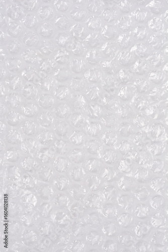 A high-angle, full-frame shot captures the textured surface of clear bubble wrap, showcasing its protective, translucent qualities as a packaging material