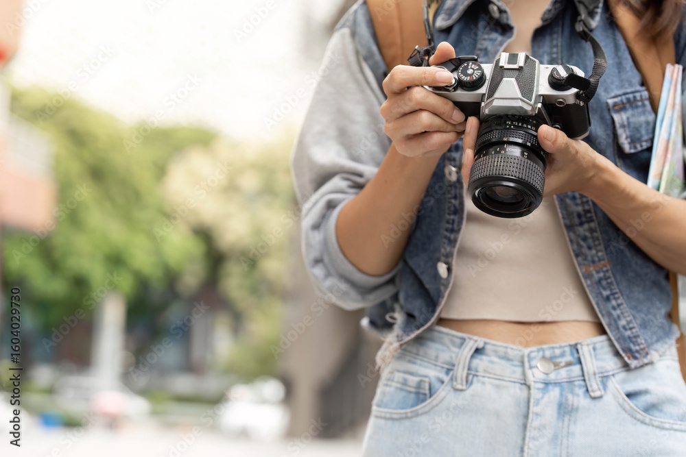 Obraz premium Photography Passion. Young woman holding camera ready to capture moments.